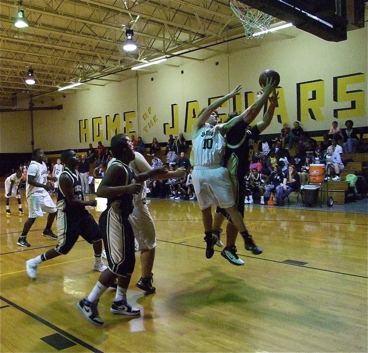 Image: Roldan battles — Kevin Roldan(50) fights for a JV Gladiator rebound.