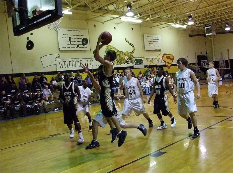 Image: Count on Justin — JV forward Justin Wood(4) puts up a shot over the Hubbard defense.