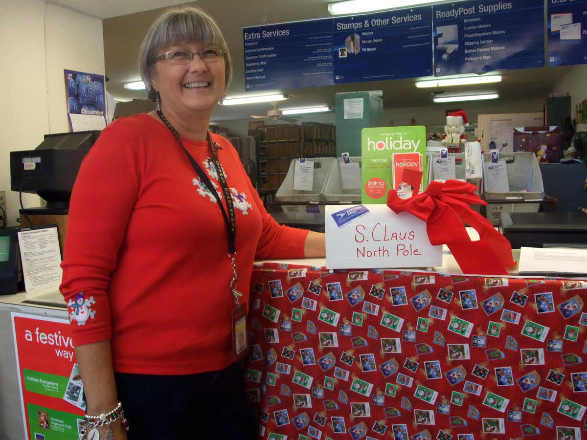 Image: Terry Adams — Terry Adams (Italy Post Master) is thrilled to have the children write letters to Santa Claus.