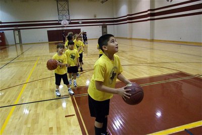 Image: Andrew eyes the target — Andrew Celis prepares to shoot a layup during warm-ups inside the Little Gym located in Hillsboro.