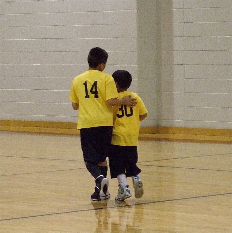 Image: Together we can — Hooping cousins Andrew Celis(14) and Jeramiah Gutierrez(30) talk strategy while changing to defense.