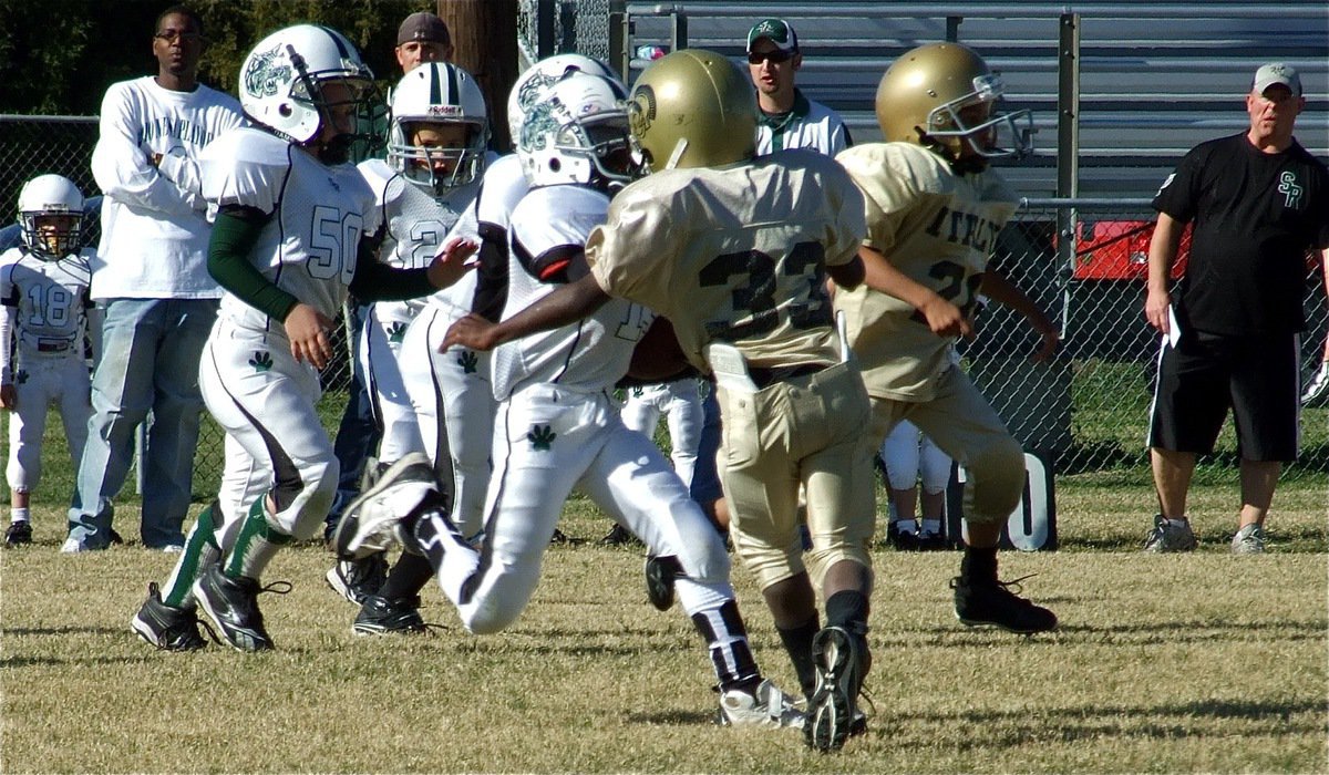 Image: Season’s greetings — Italy’s Julius Williams(33) delivers a football season’s greeting to a Scurry-Rosser runner.