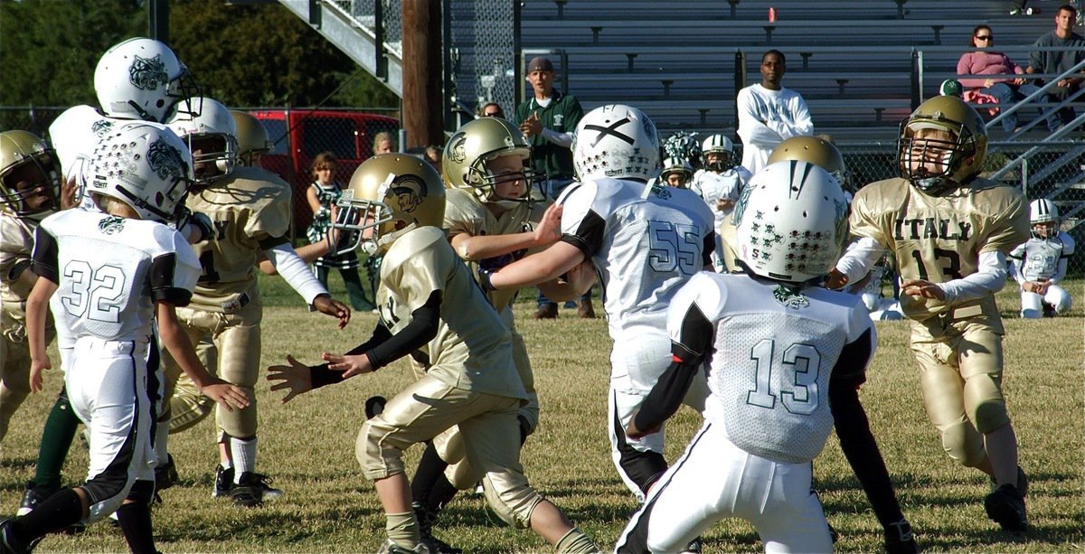 Image: Close quarters — It was a to-close-to-call shoving match between Italy’s IYAA C-Team and the Scurry-Rosser Wildcats as the game remained 0-0 until the fourth quarter. By the end of regulation, both teams were tied 6-6 before Italy won the 2010 NESA Conference Championship game 12-6 in overtime.