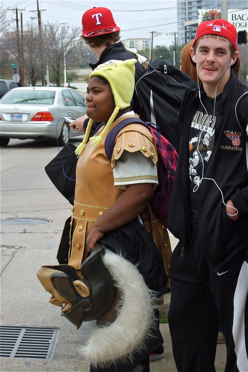 Image: Stopping traffic — Italy Gladiator mascot Sa’Kendra Norwood and team member Ryan Ashcraft are having a blast just crossing the street as players, coaches and cheerleaders make their way to the American Airlines Center in Dallas.