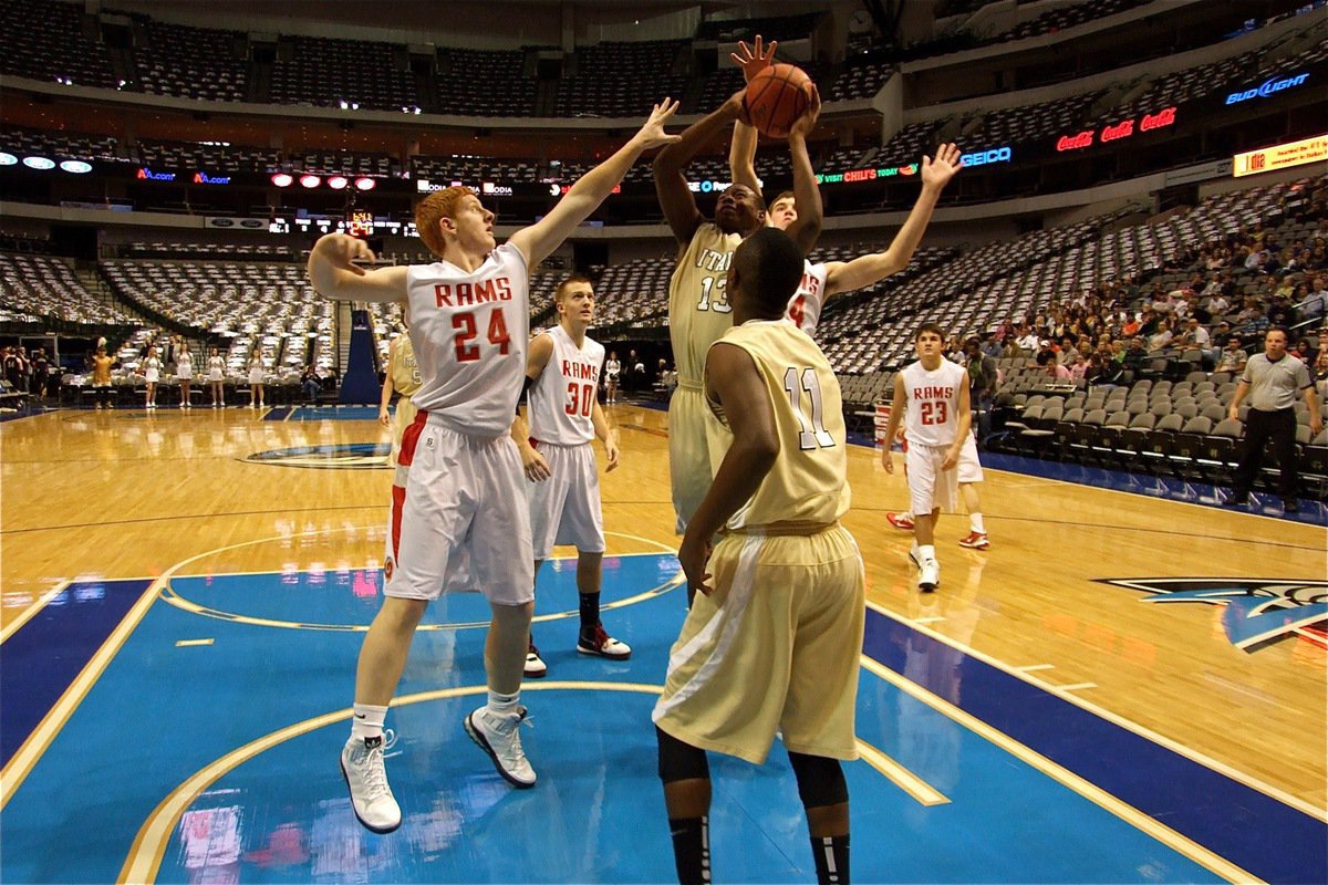 Image: In the paint — Larry Mayberry, Jr.(13) powers his way up to the goal as teammate Jasenio Anderson(11) looks on.