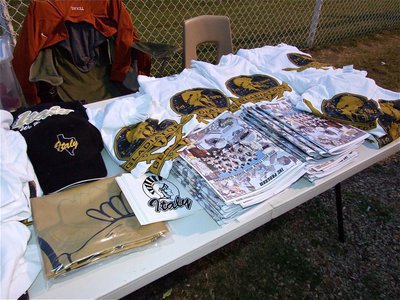 Image: Table-o-fun! — The Gladiator Booster Club has plenty of Gladiator merchandise for fans including flags, programs, caps, vehicle decals and shirts.