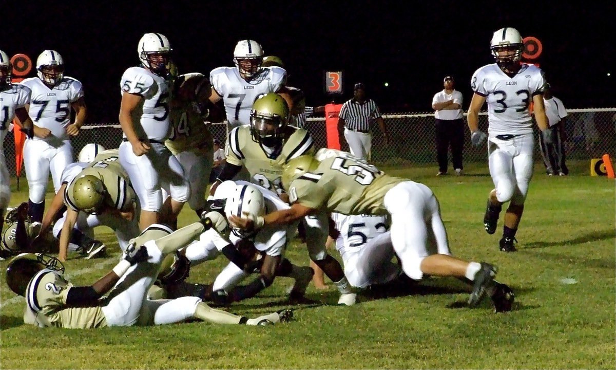 Image: Near the goal — Italy’s Heath Clemons(2), De’Andre Sephus(20) and Ethan Simon(50) bring down Leon Cougar tailback Jay Hayes(6).