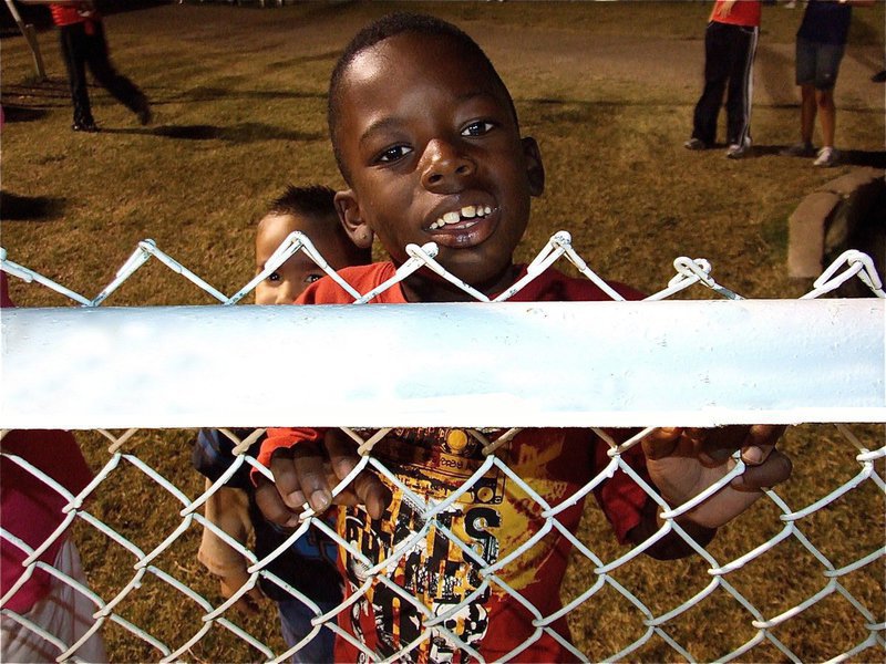 Image: I’m finally tall! — Julius Wilson is just excited he can finally see the game over the fence. “Last year, I had to watch thru the fence,” explained Julius.