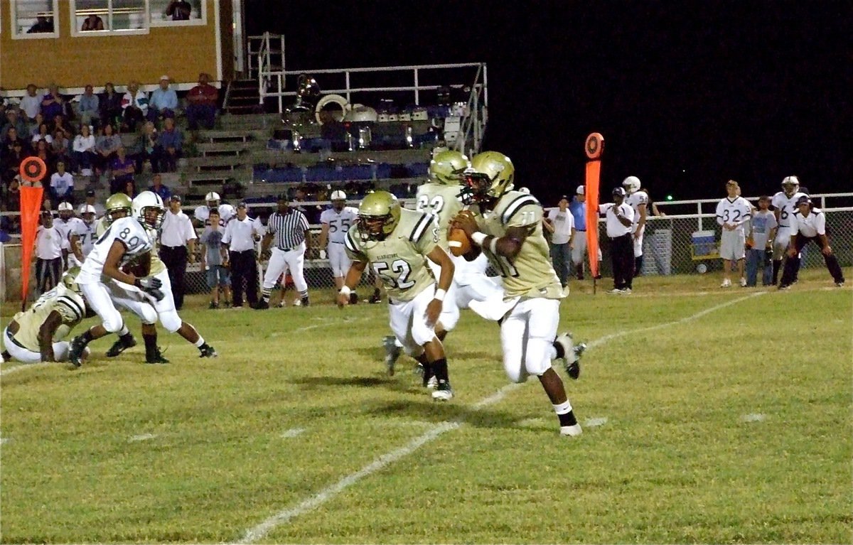 Image: Plenty of time — Offensive linemen Brandon Souder(63) and Jacob Lopez(52) buy time for Jasenio Anderson(11) to locate a receiver downfield.