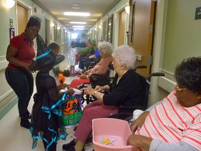 Image: Trick or Treat — Stafford students are having fun with the residents as they collect their sweet treats.