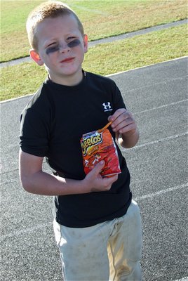 Image: Champion-chip chance — And how does hard-hitting C-Team linebacker, Ty Cash, celebrate his team’s 5th straight win? With a crunchy bag of Cheetos® of course.