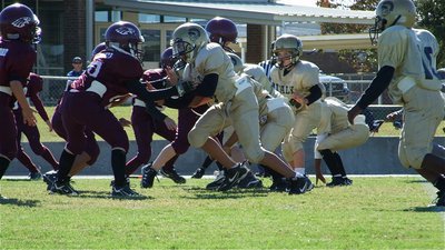 Image: The trenches — Jacob Wiser, Gage Wafer(24) and Taron Smith(10) go after the Eagles.