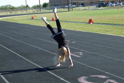 Image: Awesome flip! — Backflipping after her B-Team’s 36-0 victory over Mildred is IYAA Minors Cheerleader Lacy Mott.