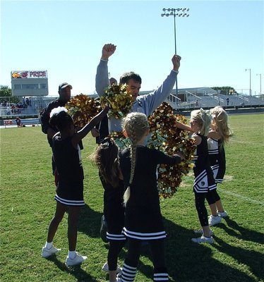 Image: Pom-Pom-Pummeled! — B-Team head coach Gary Wood gets congratulated by the IYAA Minors Cheerleaders.