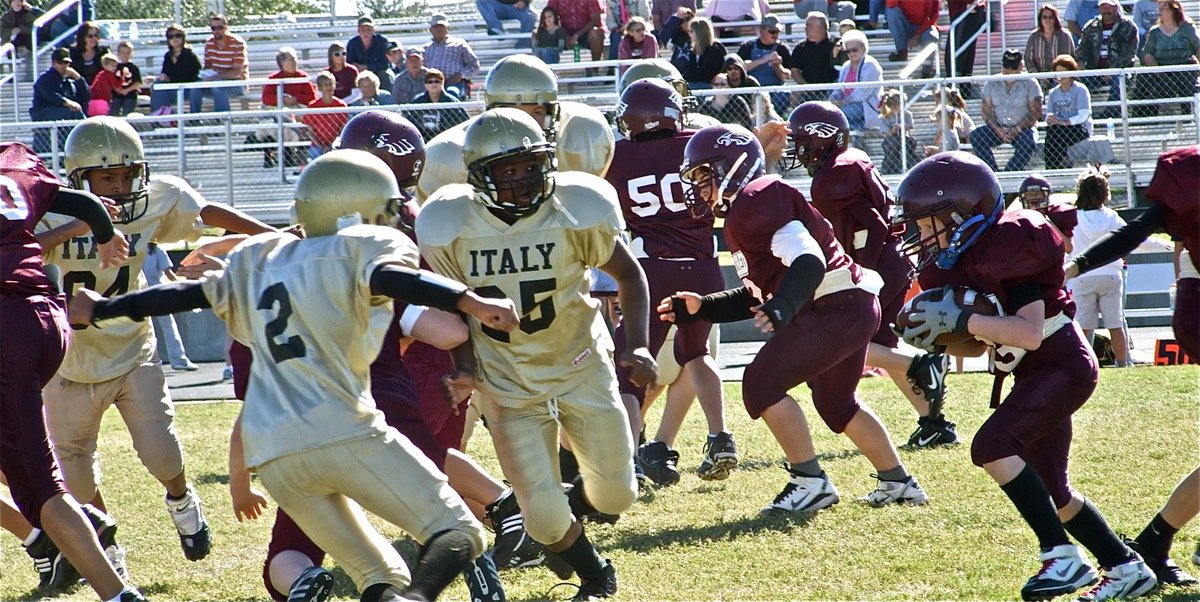 Image: Not this time! — A-Team’s Fabian Cortez(84), Tylan Wallace(2) and Kenneth Norwood(25) zero in on the Eagle runner.