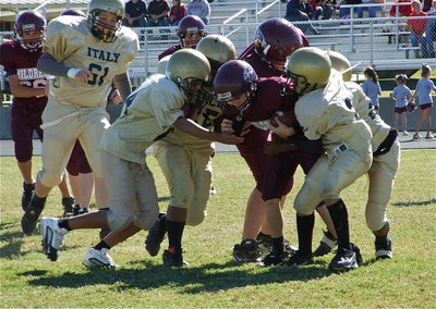 Image: Team defense — Aaron Pittmon(61) rushes in to help Fabian Cortez(84), Kenneth Norwood(25), Tylan Wallace(2) and Chasston Wilson(21) bring down an Eagle.