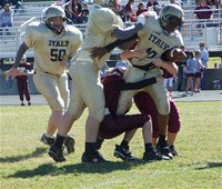 Image: Jarvis and friends — A-Team running back Jarvis Harris(10) earned the tough yards up the middle and gets a helpful push from teammate Aaron Pittmon(61) as the other half of the “Beast Brothers,” Austin Pittmon(50), hustles over to assist.