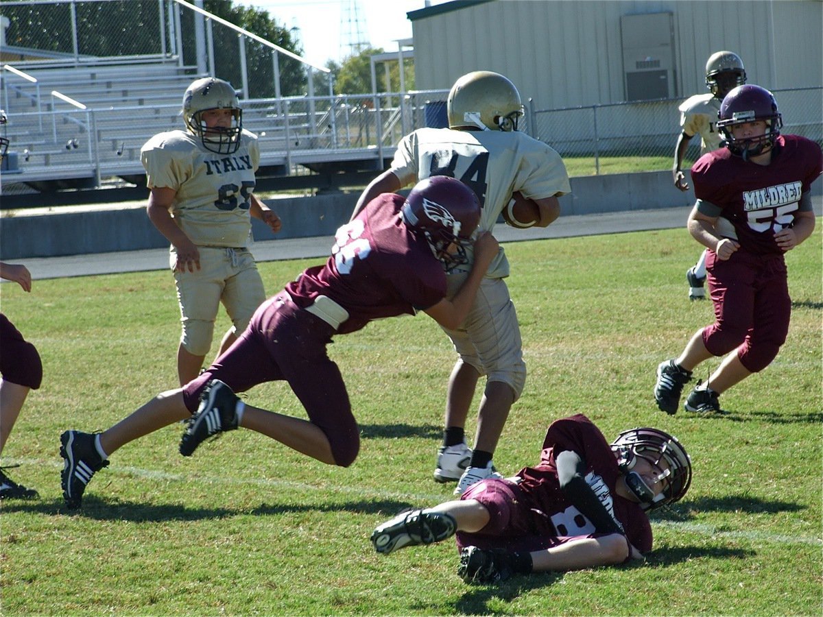 Image: Cortez gains yards — Offensive center Austin Lowe(65) keeps pace with Fabian Cortez(84) who turns upfield.