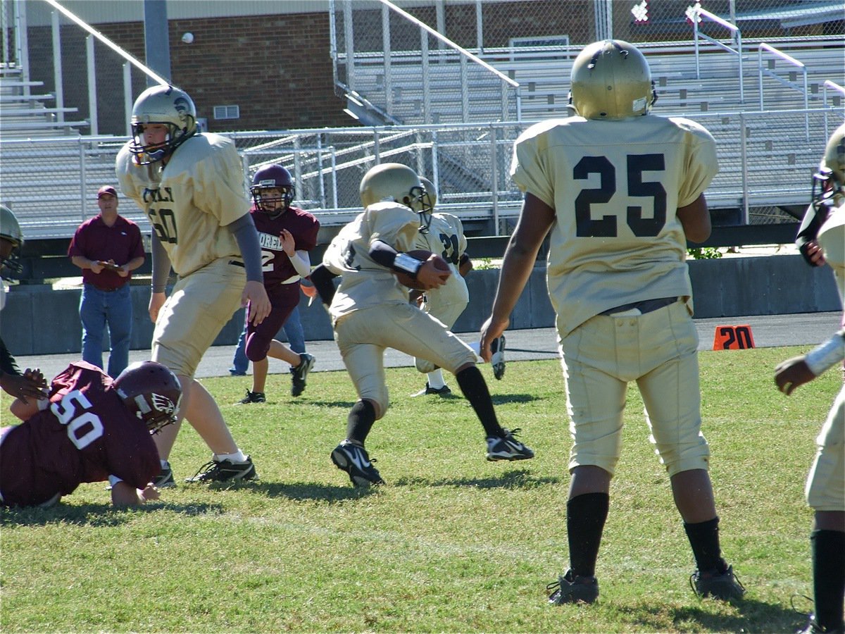 Image: Huge hole — Jarvis Harris, Austin Pittmon(50) and Kenneth Norwood(25) create an opening for Tylan Wallace(2) to run thru.