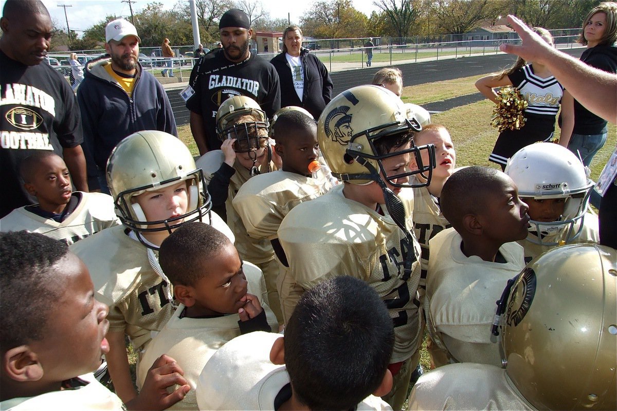 Image: Get ’em next year — The IYAA C-Team Gladiators huddle one last time after their 25-13 Superbowl loss to the Ferris Yellow Jackets.