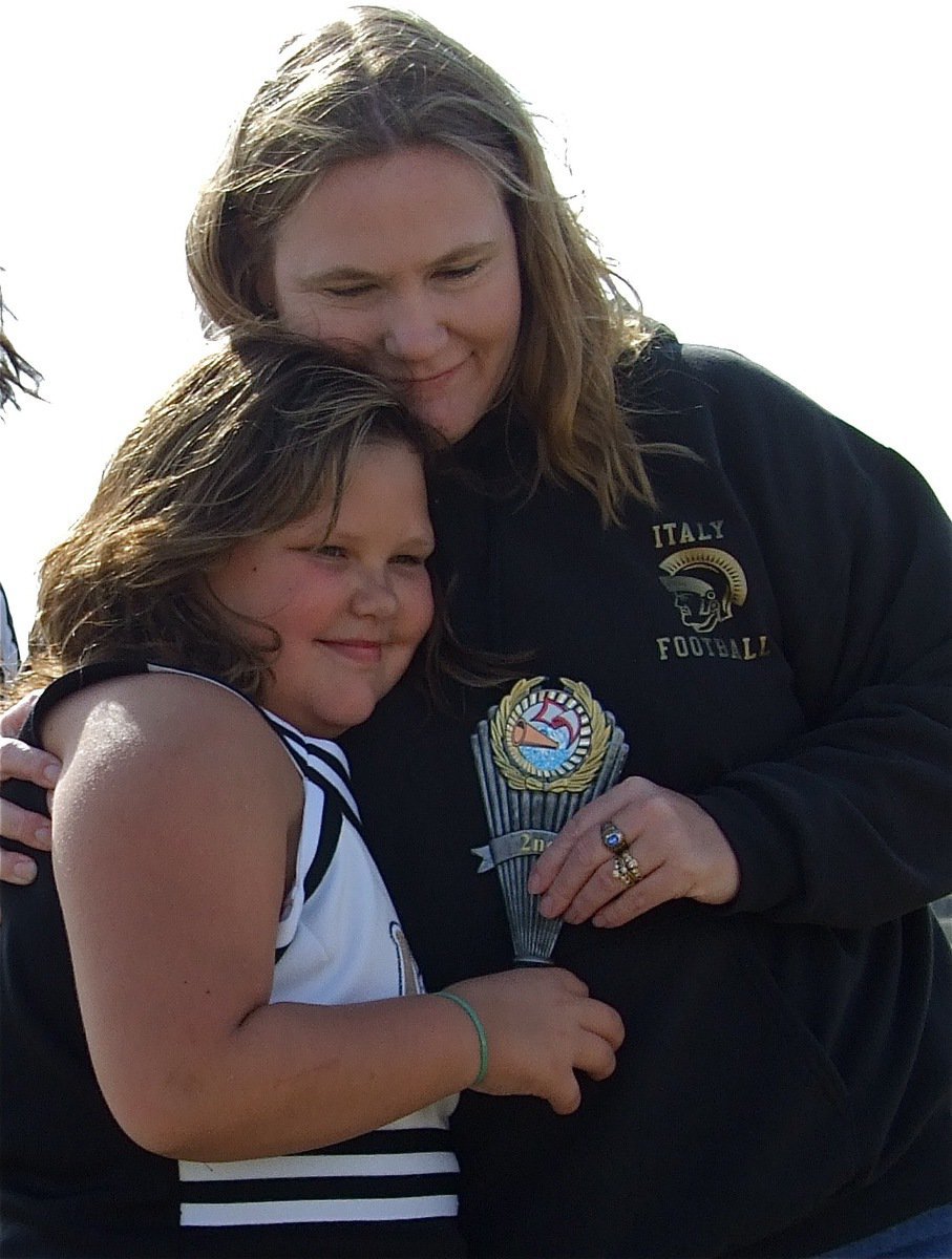 Image: So proud — IYAA Cheerleader Virginia Stephens receives her Superbowl trophy from IYAA Cheer Sponsor Becky Boyd.