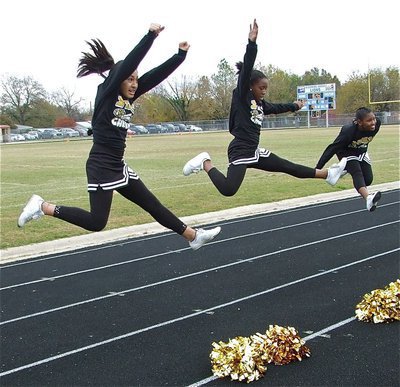 Image: The highest level — IYAA cheerleaders Elizabeth Garcia, Quintera Washington and Moesha Griffin display their athletic jumps during the Superbowl.