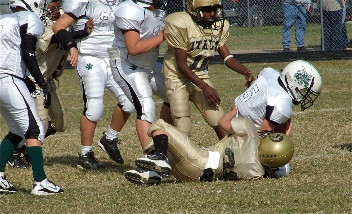 Image: Drew it up this way — Gladiator defensive lineman Drew Celis(31) brings down Scurry’s talented quarterback as Taron Smith(10) and Addison Alexander(9) power their way in.