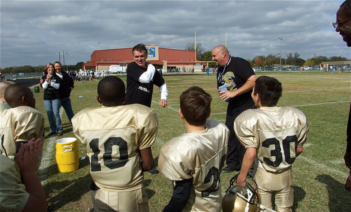 Image: Gotcha, Gary! — Assistant B-Team coach Aaron Itson squirts head coach Gary Wood with a cold water bottle to celebrate the teams Superbowl win.