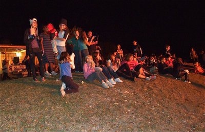 Image: Fun for all! — The IYAA family watches the bonfire brighten up the hillside.