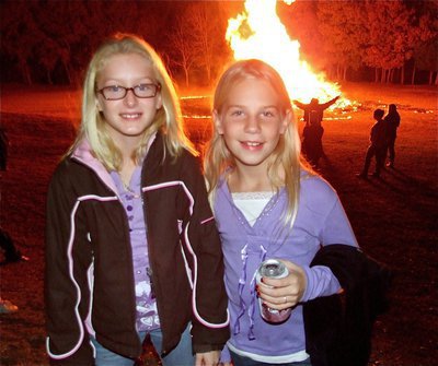 Image: IYAA Blondefire — IYAA cheerleaders Courtney Riddle and Lacy Mott show off their championship smiles that are as bright as the bonfire.