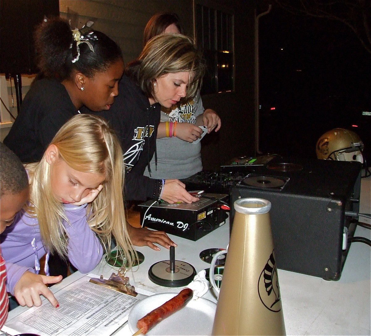 Image: We are the Champions! — IYAA Cheer Coaches Robin Wafer and Darla Wood help Quintera Washington and Lacy Mott select a song.