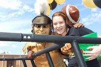 Image: Partner’s in pride — Gladiator Mascot Sa’Kendra Norwood and her partner in pride, Bailey Bumpus, get ready to ride in the Homecoming parade.