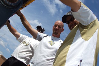 Image: Ready to ride! — Gladiator coaches Josh Ward, Jeff Richters and head coach Craig Bales hang on during the parade.