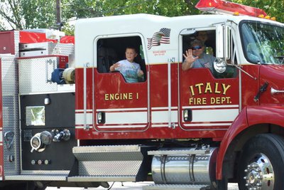 Image: Pump up the noise! — Italy volunteer fireman Ken Cate and his pumper crew join in the Homecoming fun during the parade.