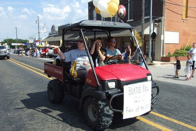 Image: Ring that victory bell! — The Gladiators’ 2010 Fan of the Year, Bertie Bell, gets an escort from Jon Mathers and Hannah Brooks who is behind the camera.