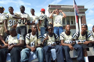 Image: Here they come! — The Italy Varsity and Junior Varsity Gladiators pass in front of Italy City Hall during the 2010 Homecoming Parade.
