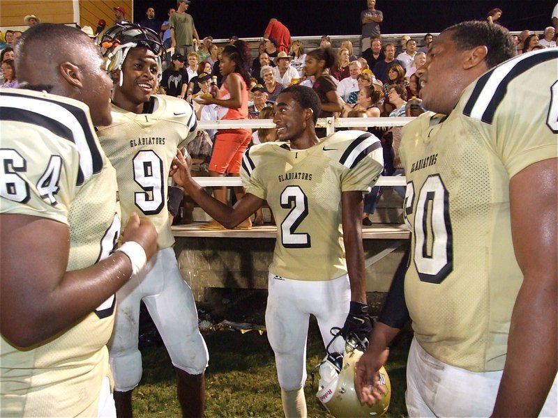 Image: Can you Believe we just did that? Believe it! — Gladiators Bobby Wilson(64), Devonta Simmons(9), Heath Clemons(2) and De’Andre Rettig(60) happily discuss the events that lead to a 93-yard touchdown run by Clemons during Italy’s 48-0 Homecoming win over Hubbard.