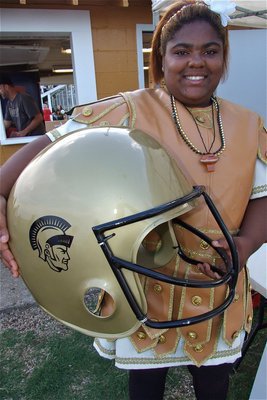 Image: Now we’re cooking! — Gladiator Mascot Sa’Kendra Norwood displays a grill cover converted into a Gladiator football helmet.