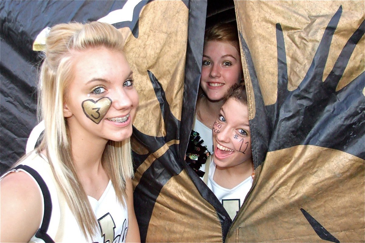 Image: Who’s there? — Sierra Harris finds Taylor Turner and Morgan Cockerham clowning in the Gladiators’ inflatable tunnel.