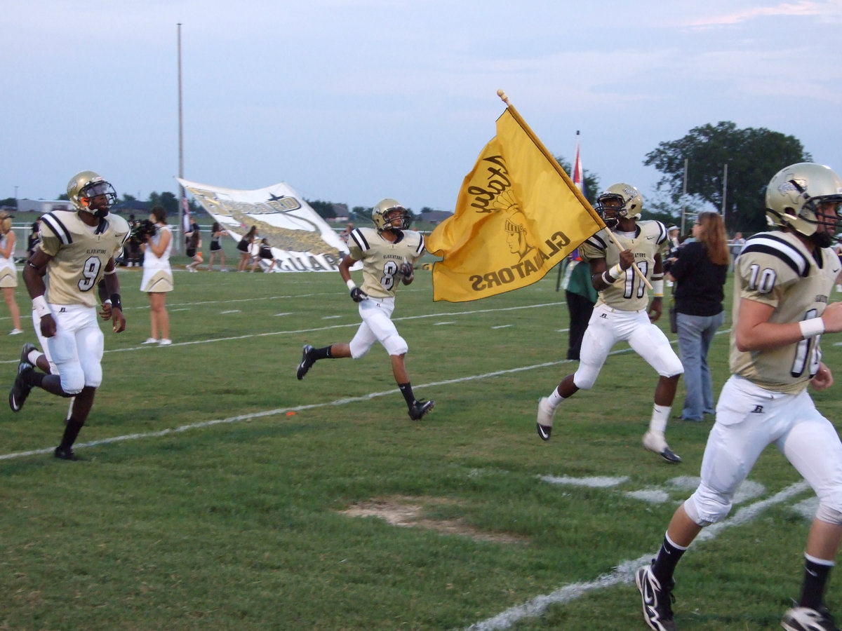 Image: The posse rides — Italy Gladiators Devonta Simmons(9), Eddie Garcia(8), Jasenio Anderson(11) and Justin Buchanan(10) rush out of the tunnel to start the homecoming game.