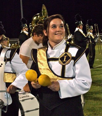 Image: Kaytlyn Bales — Gladiator Regiment Band member Kaytlyn Bales shakes, rattles and smiles during the band’s halftime performance.