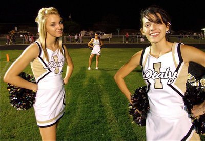 Image: 2 and a half cheers — Italy High School Cheerleaders Sierra Harris on the left and Beverly Barnhart on the right await the second half arrival of the Gladiators. Oh, that’s Anna Viers posing in the background