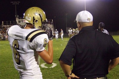 Image: They’ll never expect it! — Jase Holden(6) gets the play call from head coach Craig Bales during Friday’s game against Palmer.