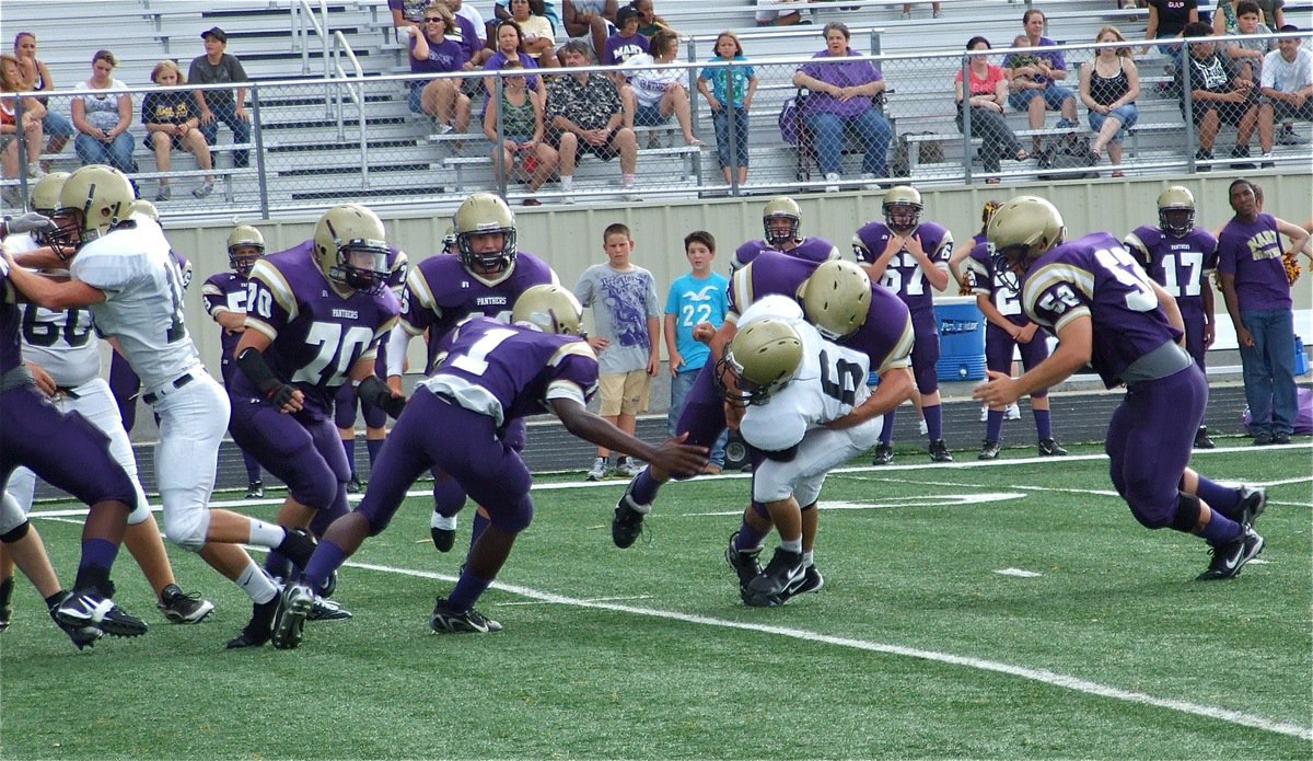 Image: No place to run — Italy’s Tony Wooldridge(6) gets trapped in the backfield by the panthers.