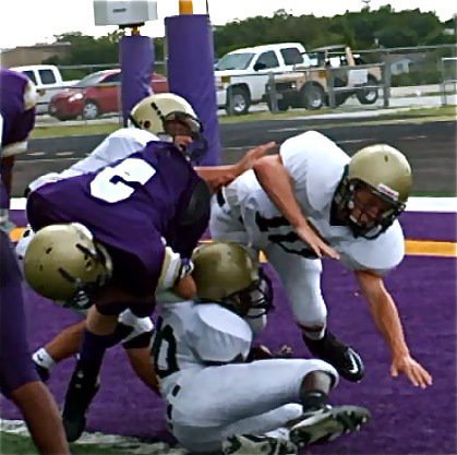 Image: Hard hitting Hamilton — Despite the efforts of Eric Carson(28), Tony Wooldridge and a hard hit delivered by Chase Hamilton(10), the Panther runner gets the ball across the goal line for a touchdown.