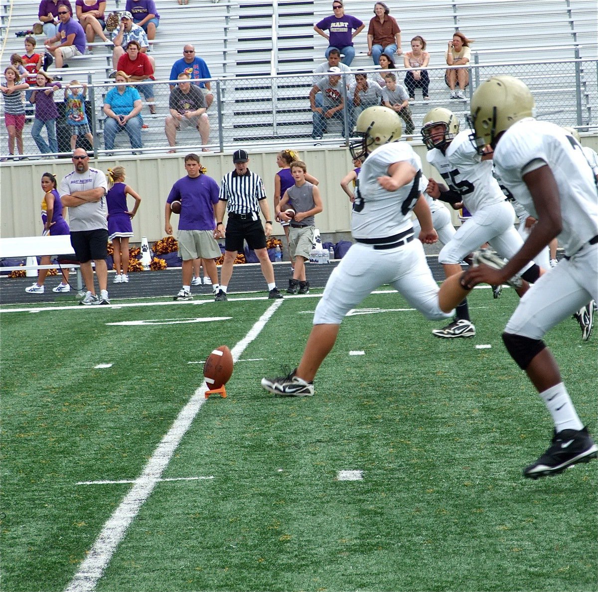 Image: The approach — Kevin Roldan(60) kicks off for the JV Gladiators.