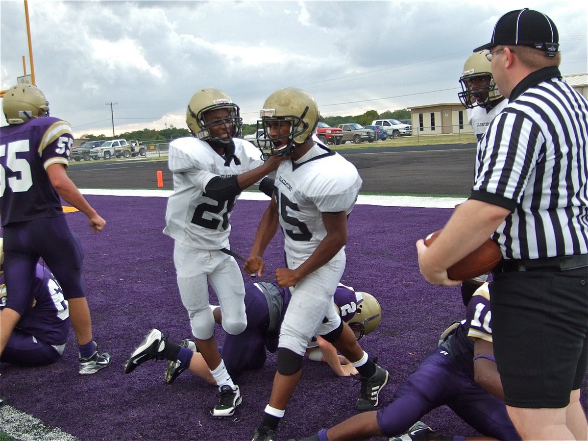 Image: Unleash the fury — Eric Carson congratulates Mike Clark(25) who lets out a bit of steam after rolling thru the Mart defenders and carrying several Panthers into the endzone for a score.