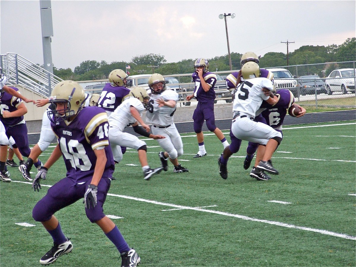 Image: Perfect position — Cody Medrano(75) challenges the lead blocker and keeps the Panther runner penned inside allowing Tony Wooldrige(6) to make the tackle for a loss.