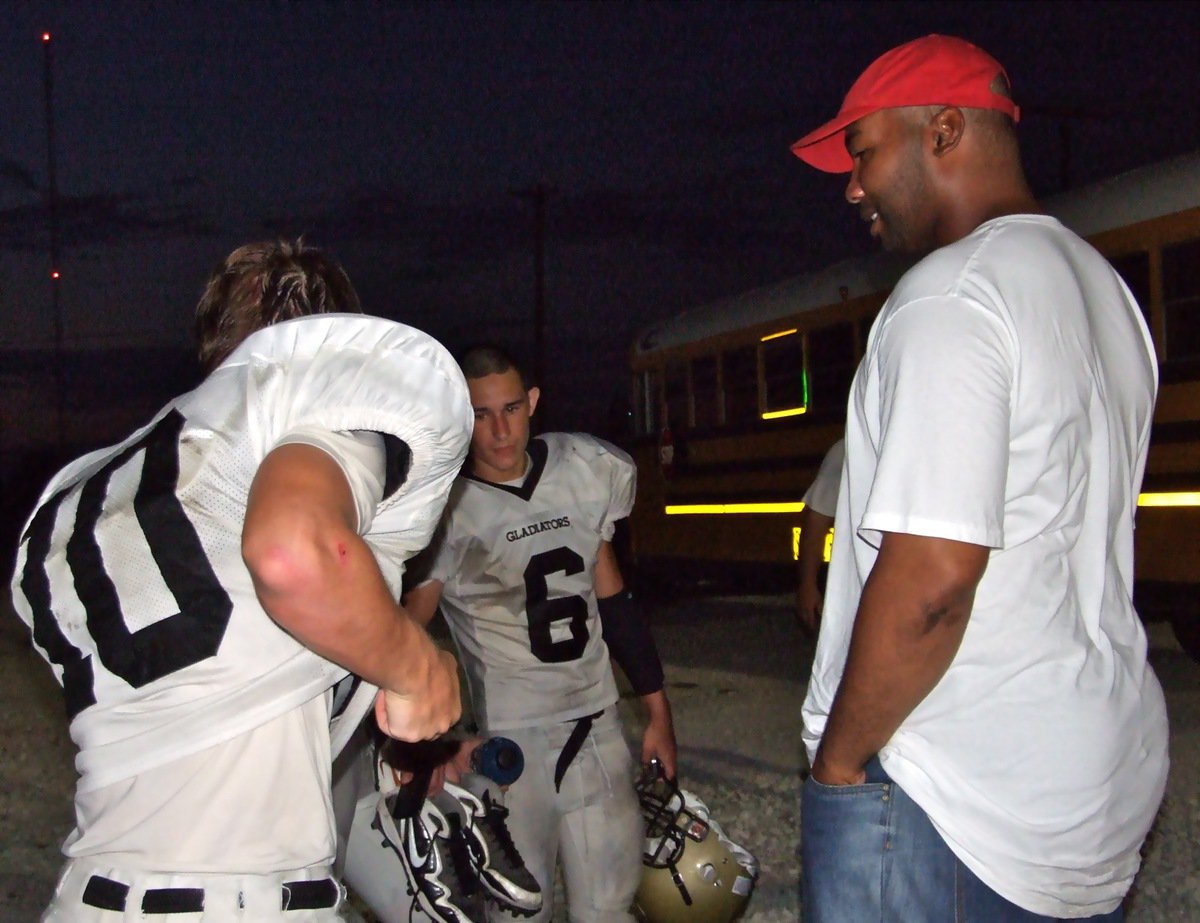 Image: Greeting Tony Brackens — After the game, Chase Hamilton(10) and Tony Wooldridge(6) visit with former University of Texas standout and NFL superstar Tony Brackens who is a long time friend of Hamilton’s.