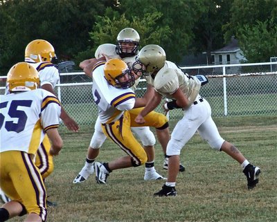 Image: Chase blocks — Chase Hamilton buys time for quarterback Tony Wooldridge(6) to release the pass downfield.